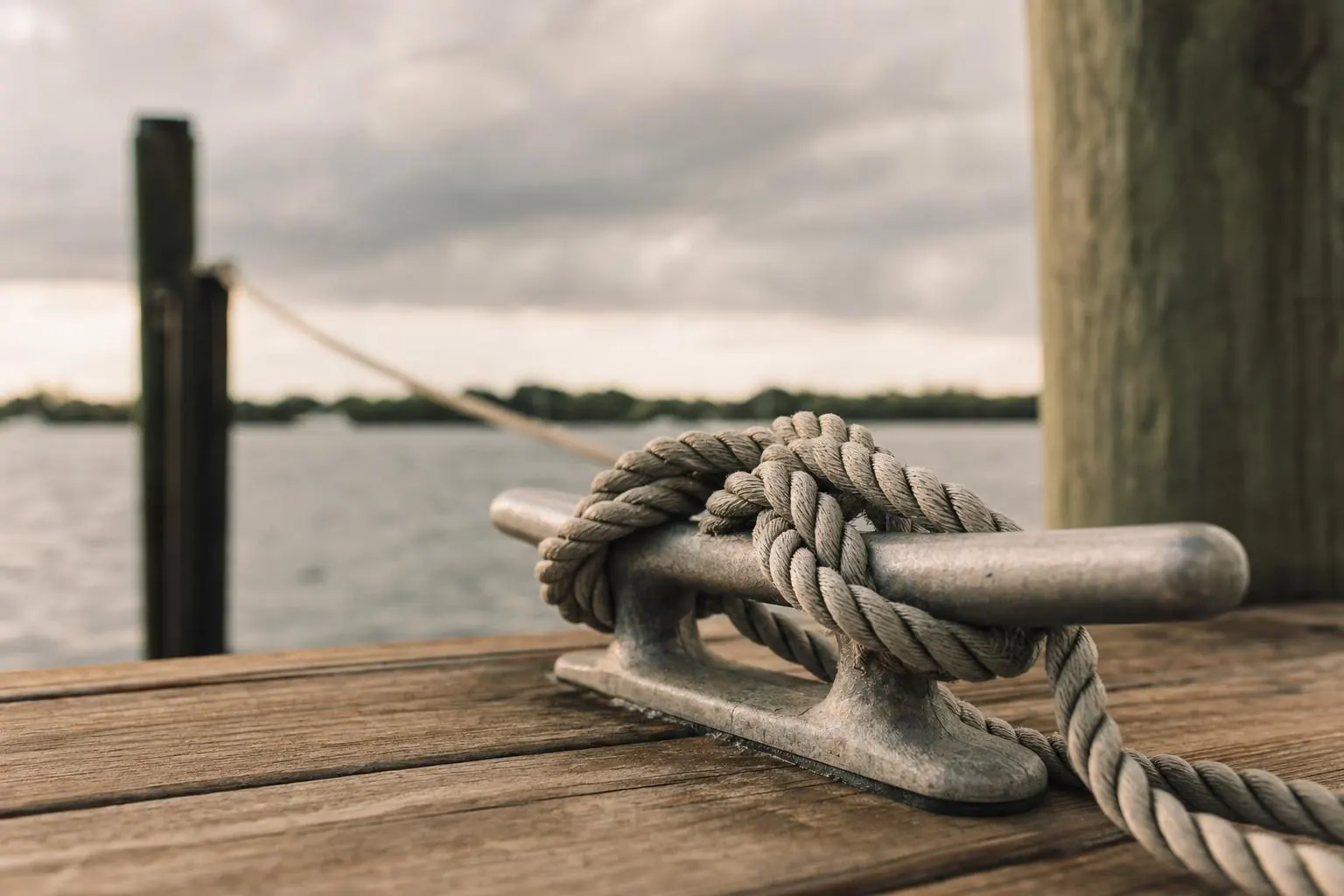 A well-secured boat at a dock before a storm